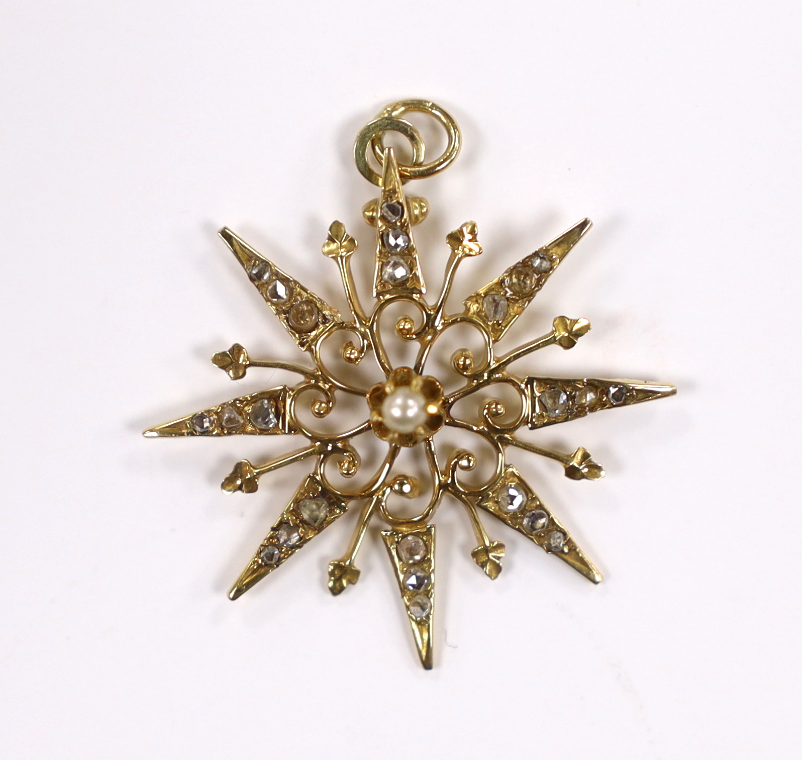 A yellow metal, rose cut diamond and seed pearl set starburst pendant, 27mm, gross weight 1.9 grams.